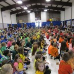 Students are dressed in rainbow colors at the assembly to honor Judi.