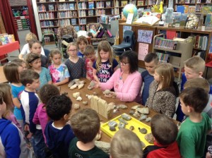 Mrs. Dalton shows her rock collection to first grade students.